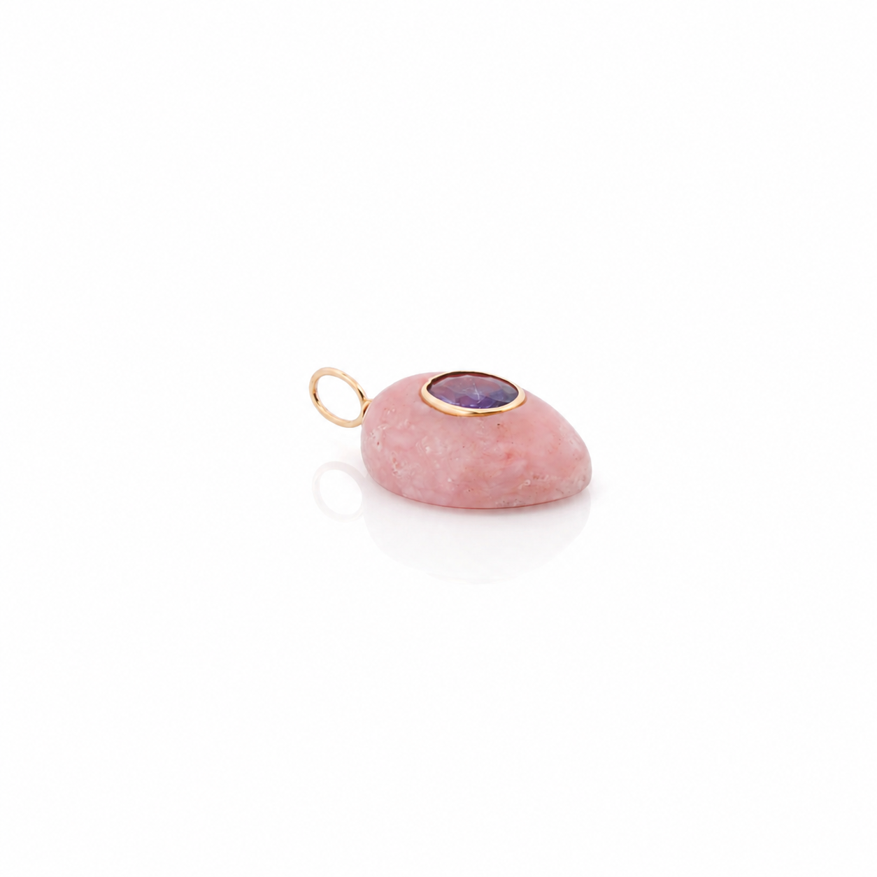 Pink stone pendant with gold and purple accents on a white background