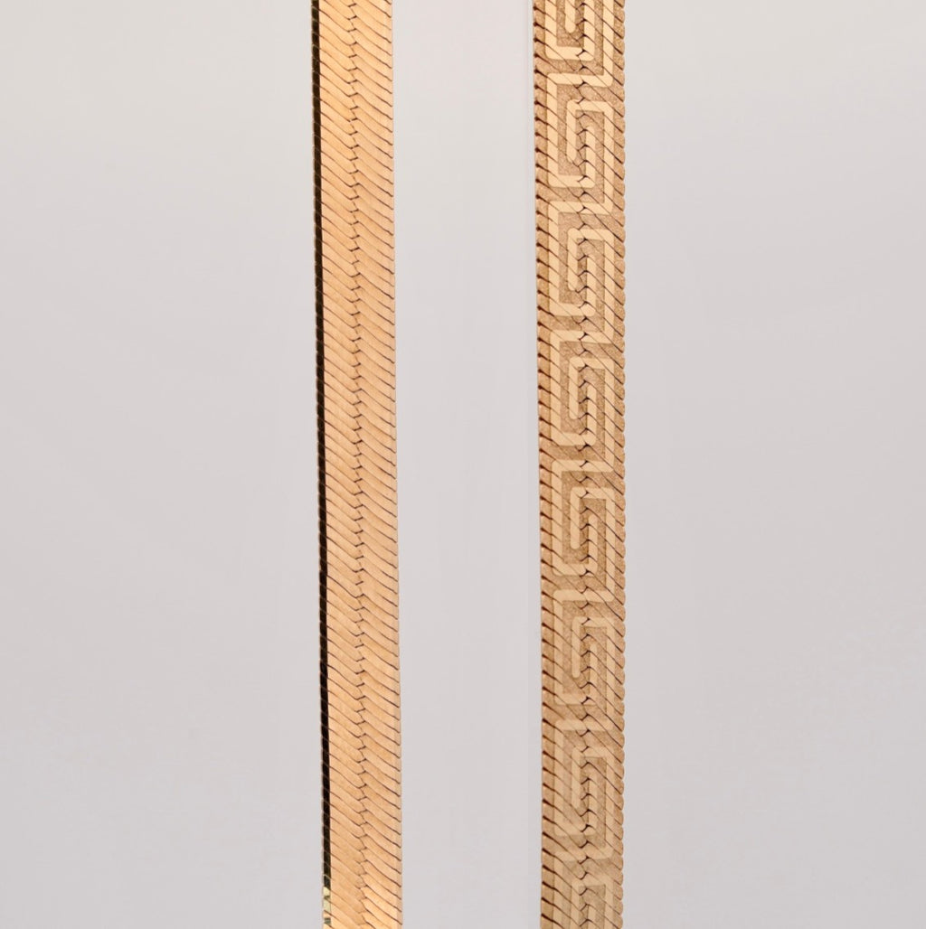 Gemmas Jewelry Edit The Aureo Dual Chain featuring a reversible gold herringbone and Greek key pattern design.