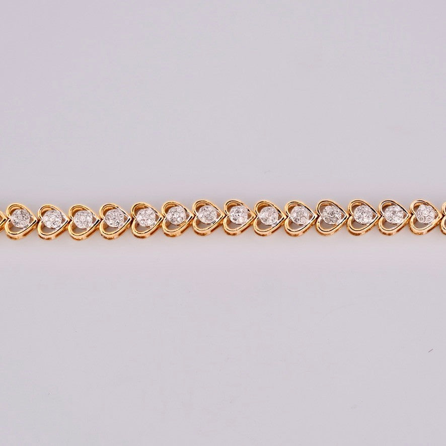Gemmas Jewelry Edit 10k yellow gold tennis bracelet with heart-shaped links and diamond clusters.