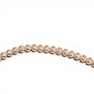 Gemmas Jewelry Edit Valentina Heart Tennis Bracelet in 10k yellow gold with diamond clusters.