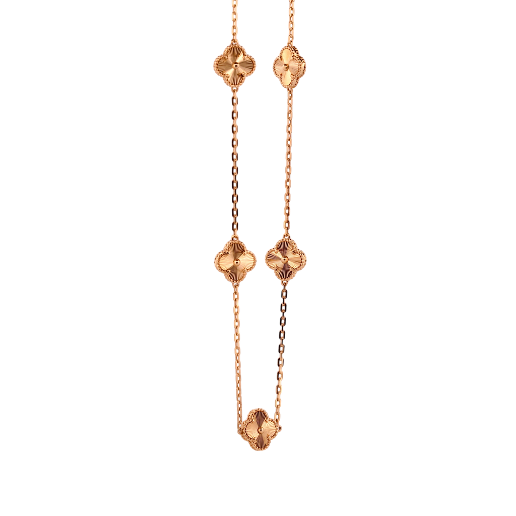Gemmas Jewelry Edit yellow gold necklace with four clover charms featuring sunburst pattern detail.