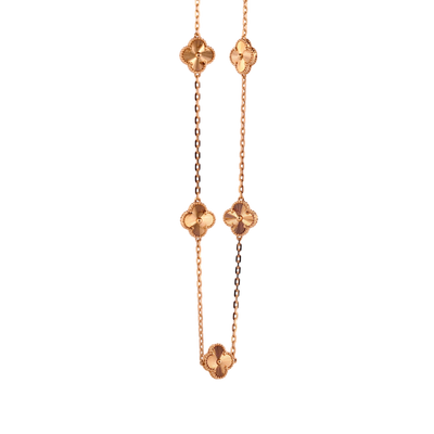 Gemmas Jewelry Edit yellow gold necklace with four clover charms featuring sunburst pattern detail.