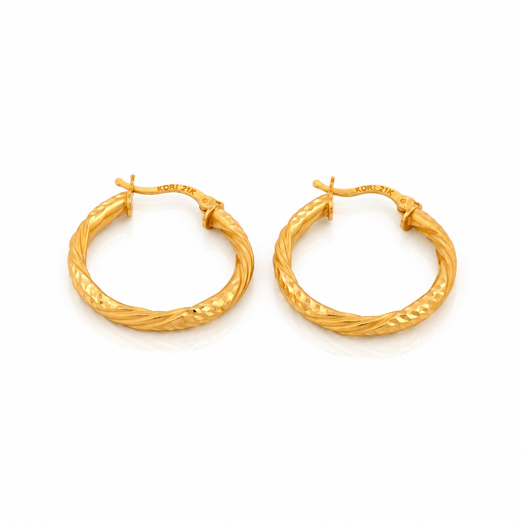 The Vela Hoops 21k yellow gold diamond cut twisted earrings