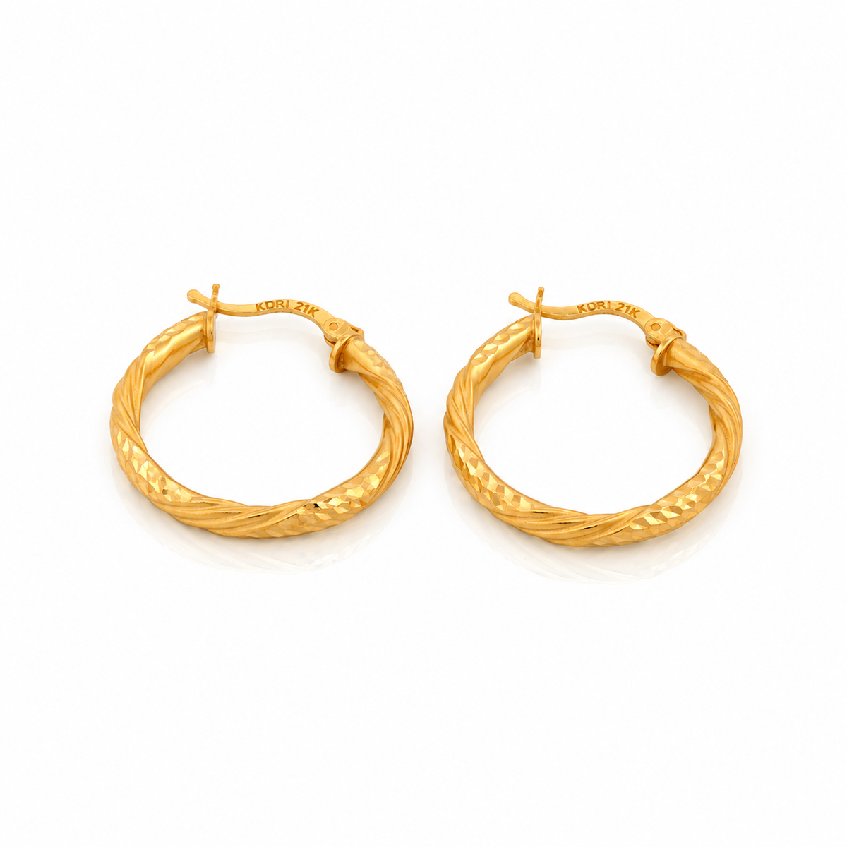 The Vela Hoops 21k yellow gold diamond cut twisted earrings