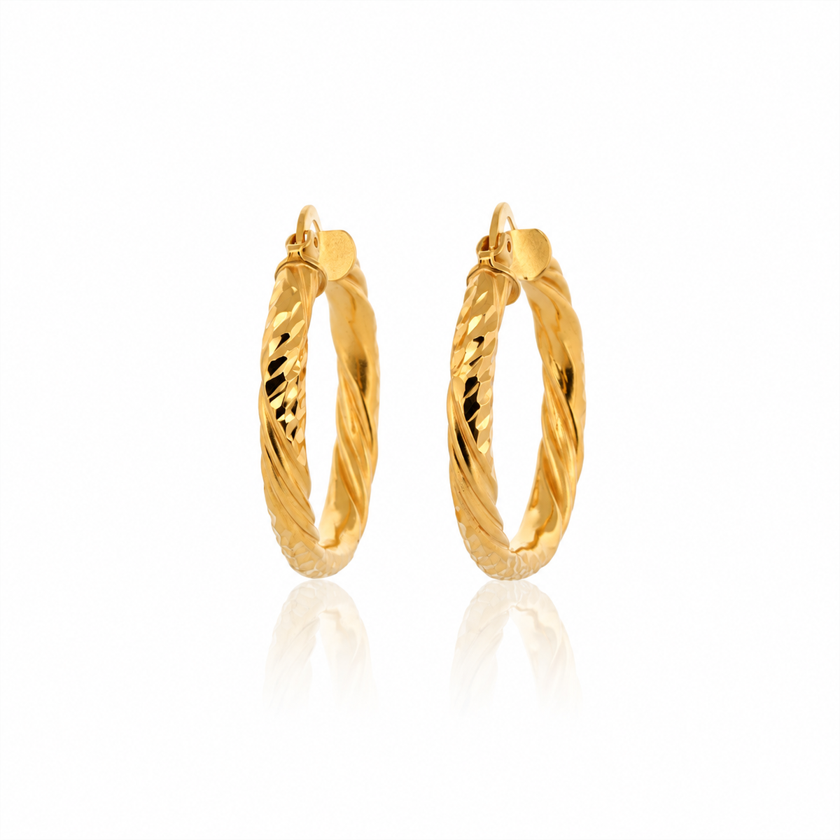 The Vela Hoops 21k yellow gold diamond cut twisted earrings