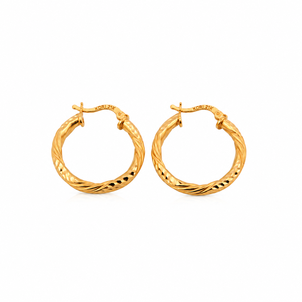 The Vela Hoops 21k yellow gold diamond cut twisted earrings